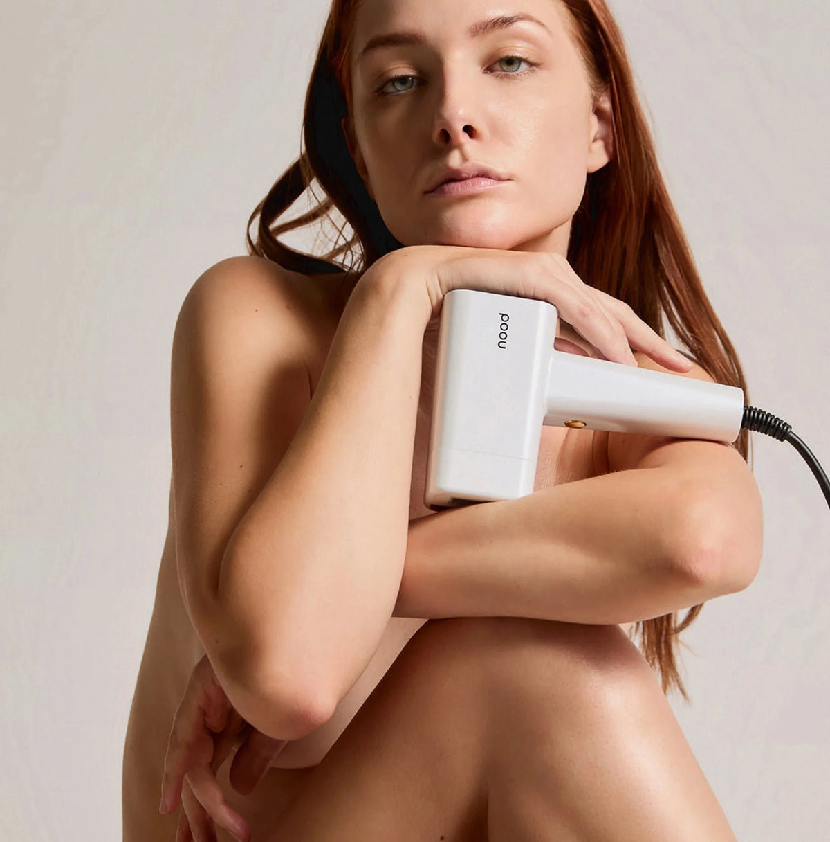 Person holding a white Nood Flasher Pro device